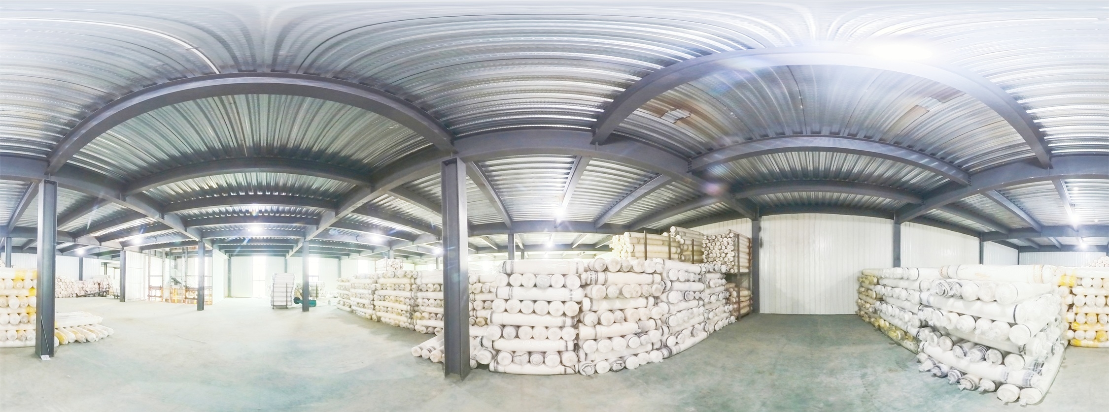 Large scale warehouse at Jiacheng Netting with finished HDPE netting rolls stacked on racks ready for export
